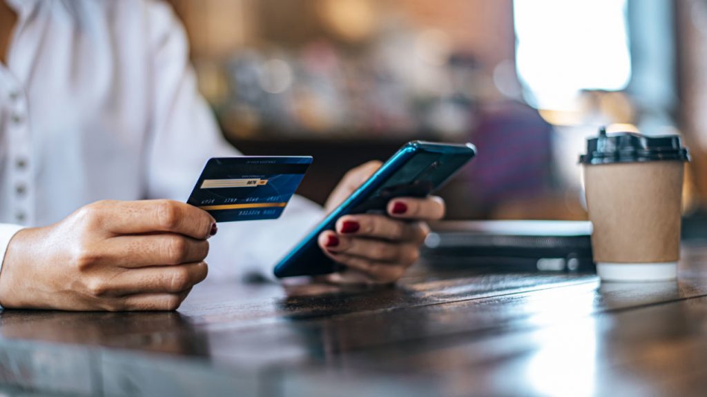 Persona usando tarjeta dé debito en línea